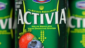 Close up of a 4-ounce Activia container, which advertises its trademark named bacterial strain, bfidius regularis. The container also includes the product’s health claim, “Helps regulate your digestive system.” The curving vertical lines mimic the female abdomen included in Activia television commercials. 